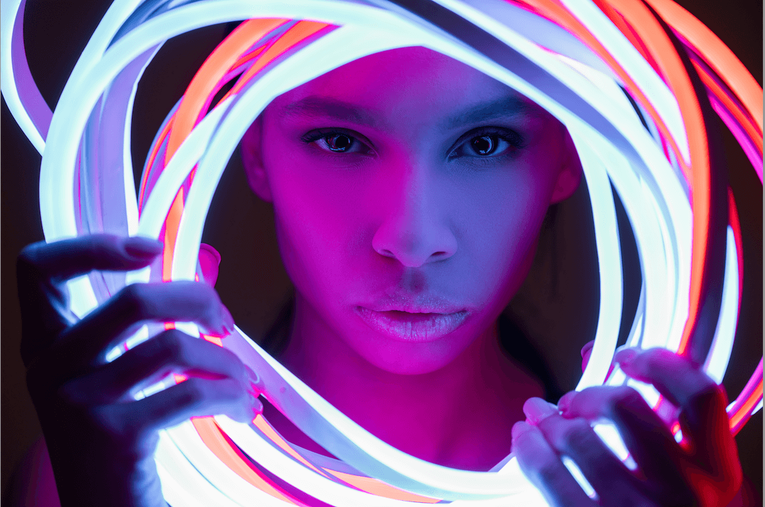 Popular image that shows a Black woman holding a bunch of glowsticks. 