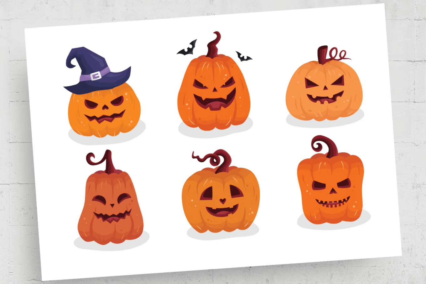 Image of six Halloween pumpkins/ jack-o-lanterns on a white background.